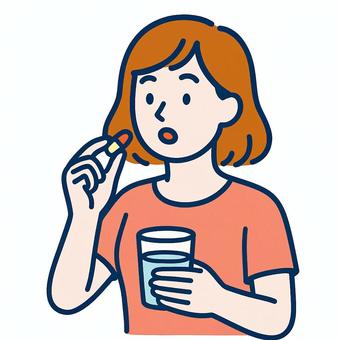 カプセル剤を飲む女性