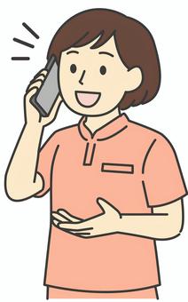 スマホで電話する女性介護士 人物,女性,介護,介助,ヘルパー,介護士,スタッフ,介護施設,スマホ,話すのイラスト素材