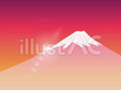 朝日がのぞくピンク色の富士山