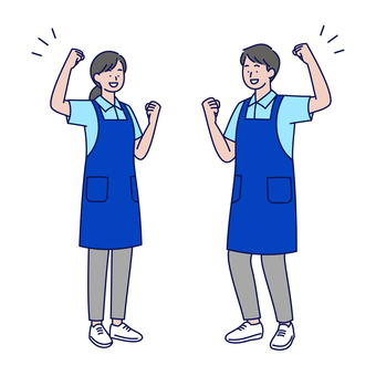 笑顔でガッツポーズするエプロン姿の男女