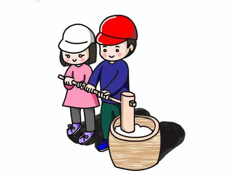 餅つきをしているこども