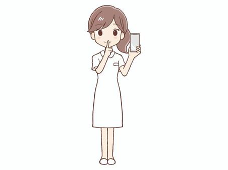 白衣の女性が携帯を持ちお静かにのポーズ 女,白衣,静か,内緒,ポーズ,携帯,電話,スマホ,スマートフォン,看護師のイラスト素材
