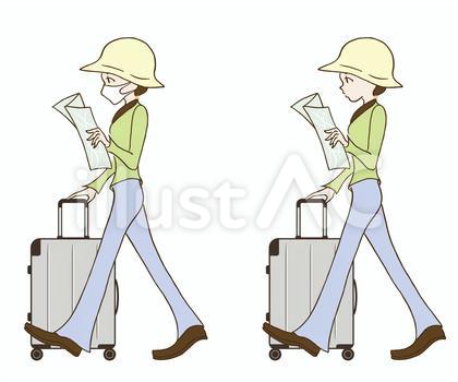スーツケースを持って歩いてる女性