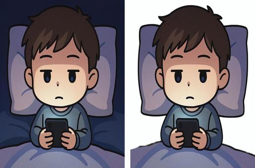 布団の中でスマホをする男の子