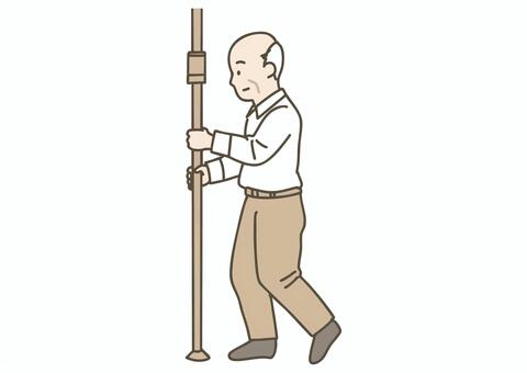 手すり（縦型ポール）を持って立つ高齢男性 手すり,縦手すり,ポール,つかまり立ち,立ち上がり,杖,高齢者,シニア,男性,介護のイラスト素材