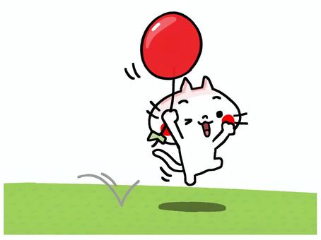 風船と一緒に飛んで遊ぶ猫