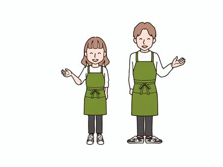片手を上げる男女2_エプロンgr 大人,男性,女性,男女,ペア,おそろい,全身,エプロン,ズボン,パンツのイラスト素材
