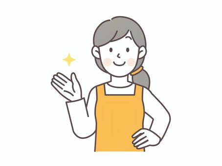 腰に手を当てて案内する主婦_ピンク 主婦,エプロン,人物,女性,若い,ママ,専業主婦,シンプル,母,かわいいのイラスト素材