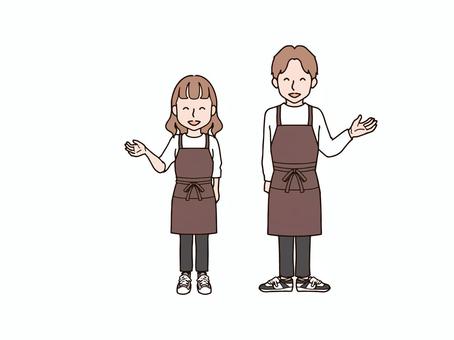 片手を上げる男女2_エプロンbr 大人,男性,女性,男女,ペア,おそろい,全身,エプロン,ズボン,パンツのイラスト素材