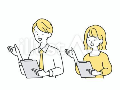 後ろを指しながら説明する男女