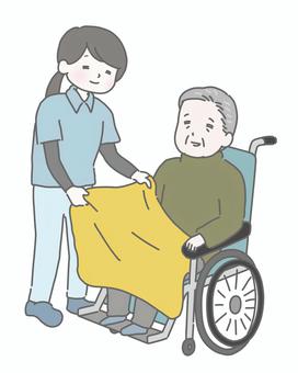 介護士が膝掛けをかけるおじいさん 介護,高齢者,老人,介護士,介護施設,デイサービス,車椅子,ブランケット,冬,シニアのイラスト素材
