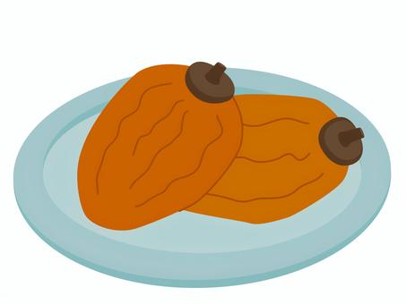 皿に乗った干し柿２つ 干し柿,柿,ドライフルーツ,丸ごと,果物,秋,旬,フルーツ,食べ物,白背景のイラスト素材