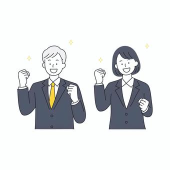 ガッツポーズをするビジネス男女