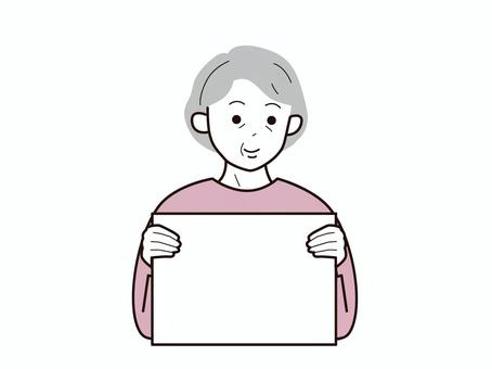 フリップを持ち笑むシニア女性2／カラー 上半身,長袖,フリップ,両手,微笑む,おばあさん,老人,高齢者,シニア,女性のイラスト素材