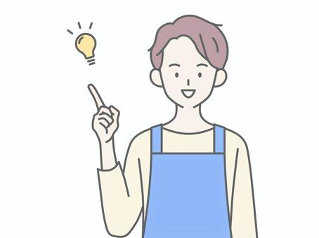 良いことをひらめくエプロンの男性 良いことをひらめくエプロンの男性 人物,男,エプロン,主夫,保育士,ヘルパー,介護士,正面,笑顔,かっこいいのイラスト素材