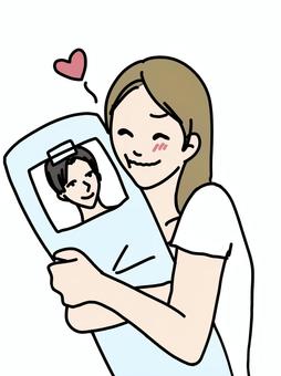 推しの写真を抱き枕に貼る女性 女性,推し活,抱き枕,写真,アイドル,モデル,芸能人,キャラクター,テープ,貼るのイラスト素材