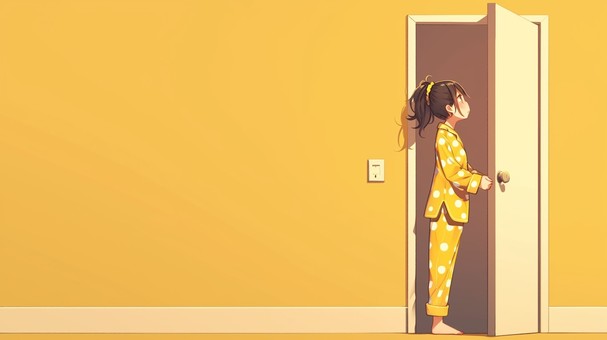 黄色いドット柄のパジャマを着た少女
