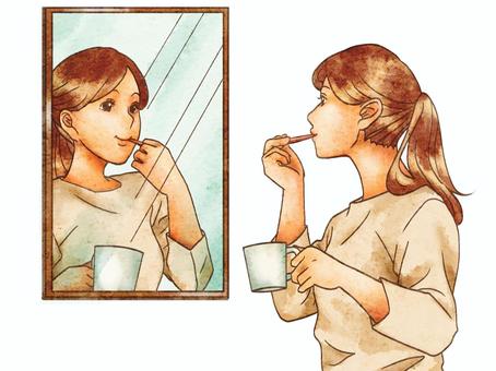 A woman brushing her teeth in the mirror A woman brushing her teeth in the mirror