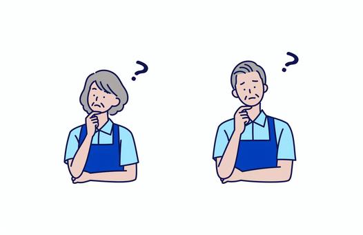 困った表情で考えるシニアスタッフの男女 人物,男性,女性,高齢者,シニア,エプロン,困る,考える,表情,制服のイラスト素材