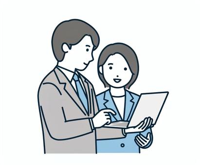 パソコンを見て話し合うビジネスパーソン