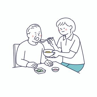 食事を介助する介護士と高齢男性