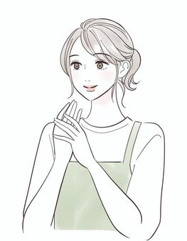 笑顔でハンドケアをするエプロン姿の女性 女性,人物,きれい,おしゃれ,可愛い,表情,スキンケア,肌,触る,ケアのイラスト素材