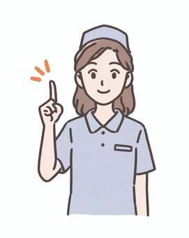 笑顔で指を立てる女性ナース