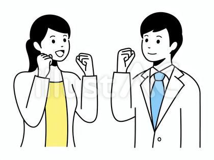 向かい合ってガッツポーズをする男女会社員
