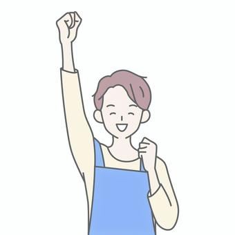こぶしを上げて笑うエプロンの男性 こぶしを上げて笑うエプロンの男性 人物,男,エプロン,主夫,保育士,ヘルパー,介護士,拳,ガッツポーズ,やったーのイラスト素材