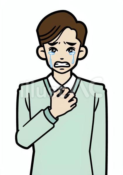 涙を流す若い私服の男性