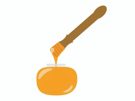 ビンに入った蜂蜜とハニーディッパー
