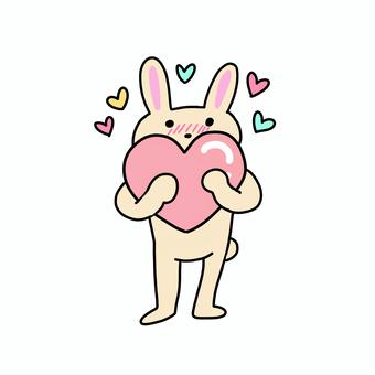 ハートを持って赤面するうさぎ