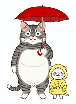 傘をさす猫とレインコートの子猫