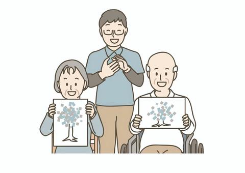 高齢者と職員が完成した工作作品を披露 介護,介護士,職員,レクリエーション,工作,創作活動,作品,趣味,手芸,高齢者のイラスト素材