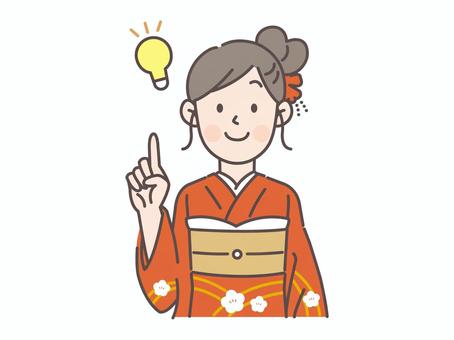 指差しアイディアを思いつく振袖の女性1