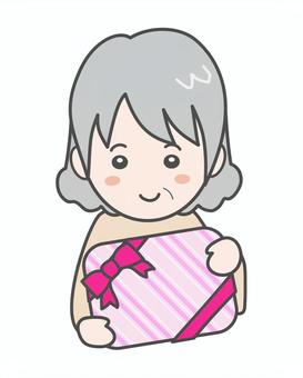 プレゼントを貰って笑顔の女性＿高齢者 女性,プレゼント,リボン,母の日,母,祖母,敬老の日,高齢者,おばあちゃん,誕生日のイラスト素材