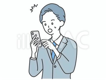 スマホを見て驚くビジネスマン