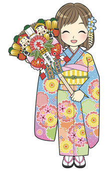 A woman with a light blue furisode holding a rake A woman with a light blue furisode holding a rake
