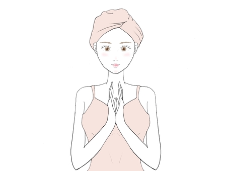 A woman who smiles with her hands together before washing her face A woman who smiles with her hands together before washing her face