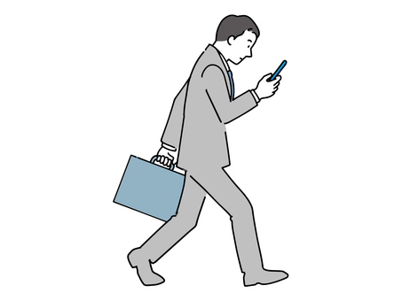 Office worker walking while looking at a smartphone Office worker walking while looking at a smartphone
