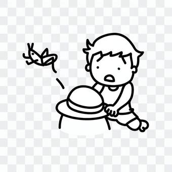 A boy trying to grab a grasshopper A boy trying to grab a grasshopper