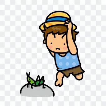 A boy trying to grab a grasshopper A boy trying to grab a grasshopper