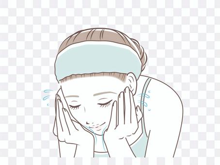 Woman washing her face with water Woman washing her face with water