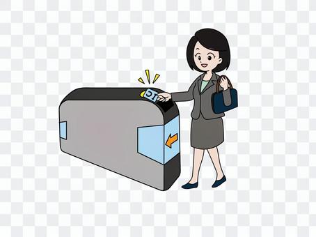 A woman commuting by holding an IC card over the ticket gate A woman commuting by holding an IC card over the ticket gate