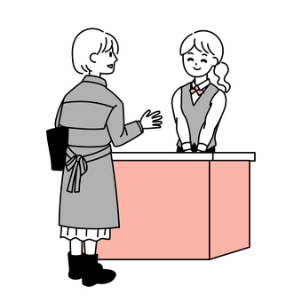 A woman talking to the receptionist A woman talking to the receptionist