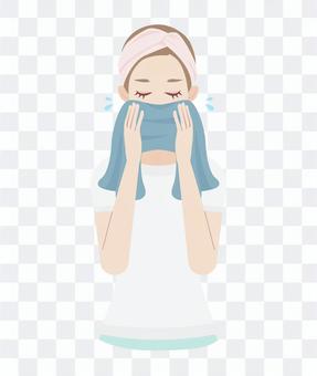 Women wiping their face with a skin care towel Women wiping their face with a skin care towel