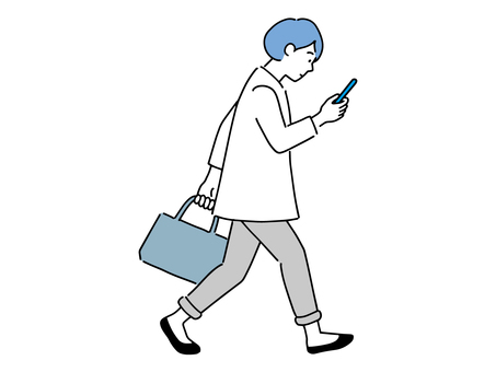 A woman walking while looking at a mobile phone A woman walking while looking at a mobile phone